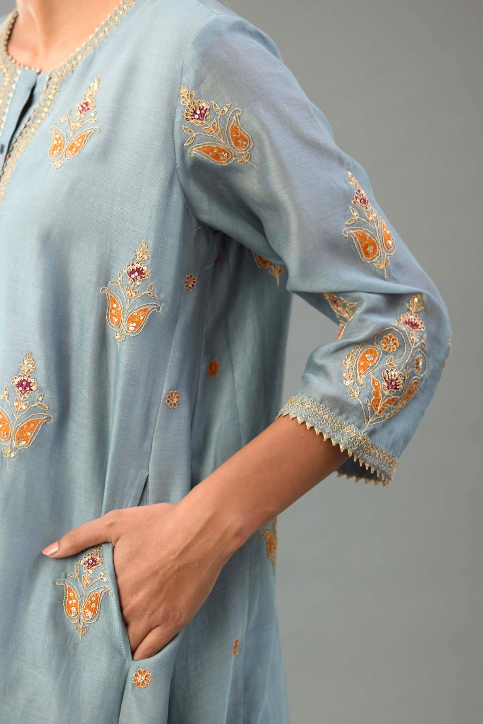 Light blue silk chanderi A-line short kurta set with dori and contrast silk thread embroidery, highlighted with gold sequins work.