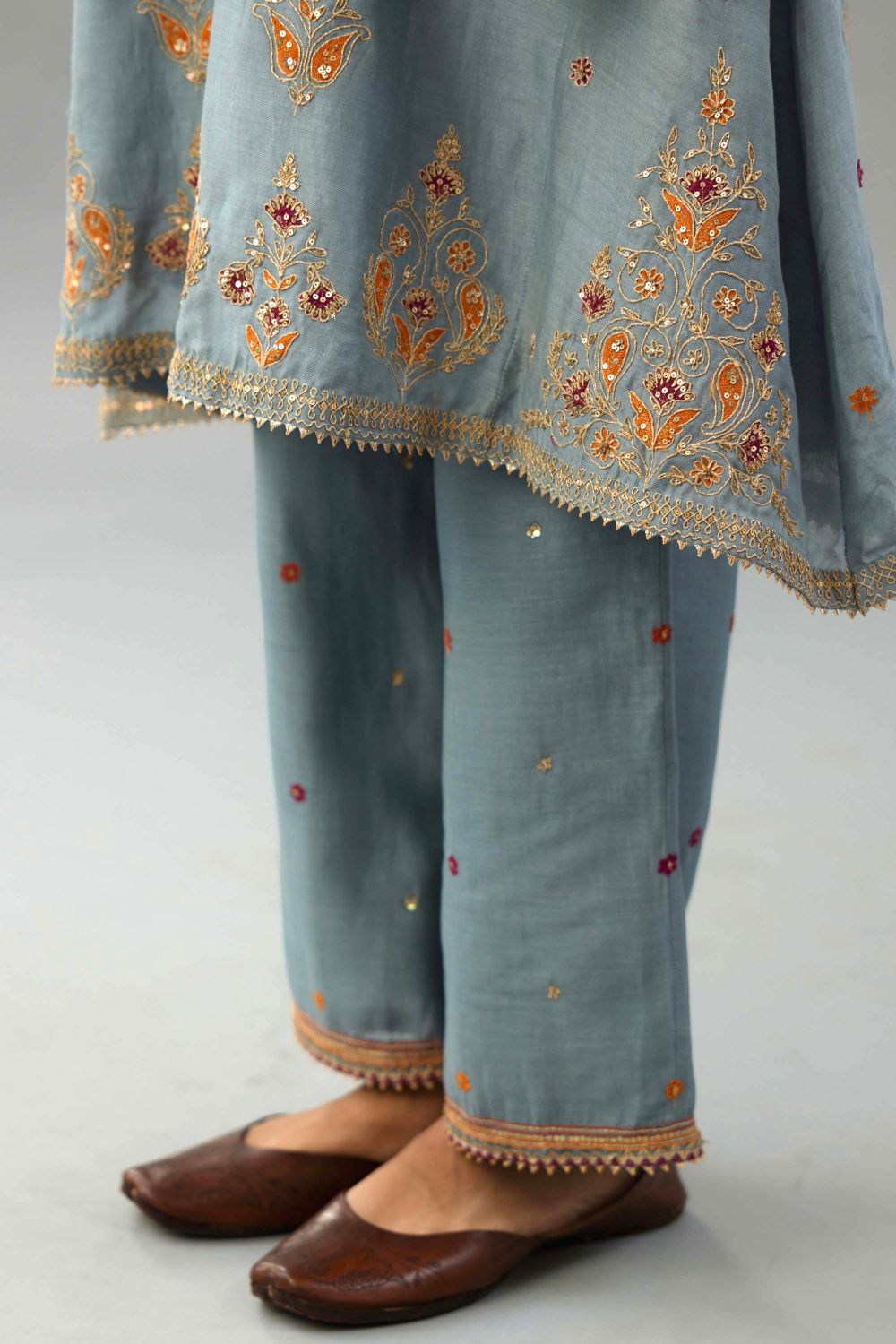 Light blue silk chanderi A-line short kurta set with dori and contrast silk thread embroidery, highlighted with gold sequins work.