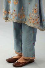 Light blue silk chanderi A-line short kurta set with dori and contrast silk thread embroidery, highlighted with gold sequins work.
