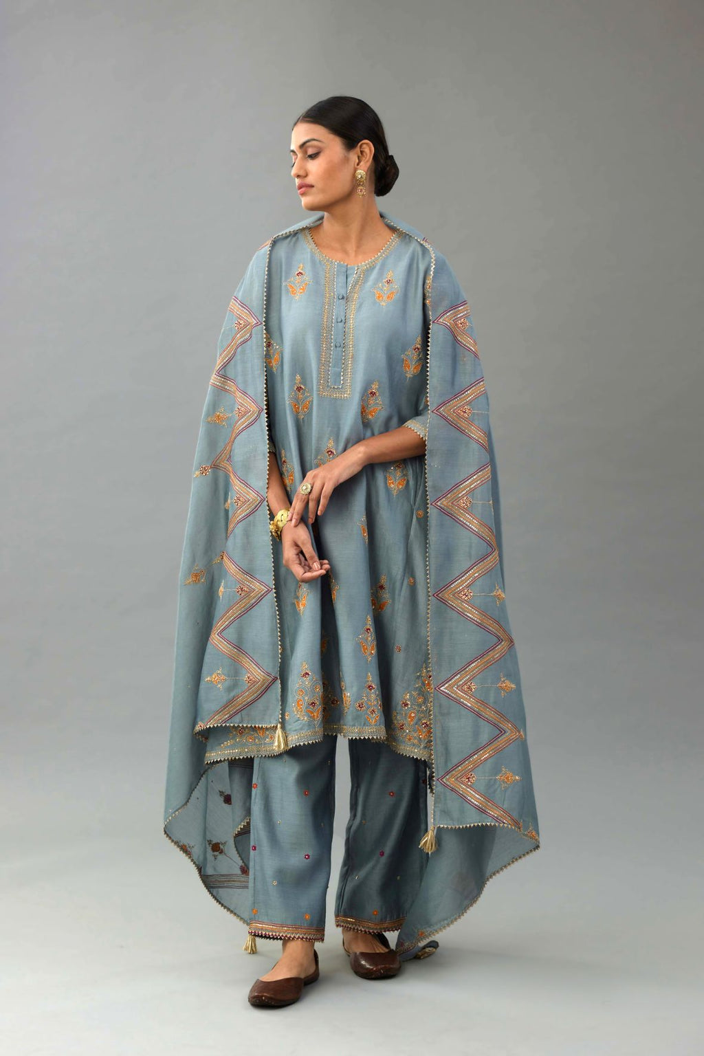 Light blue silk chanderi A-line short kurta set with dori and contrast silk thread embroidery, highlighted with gold sequins work.