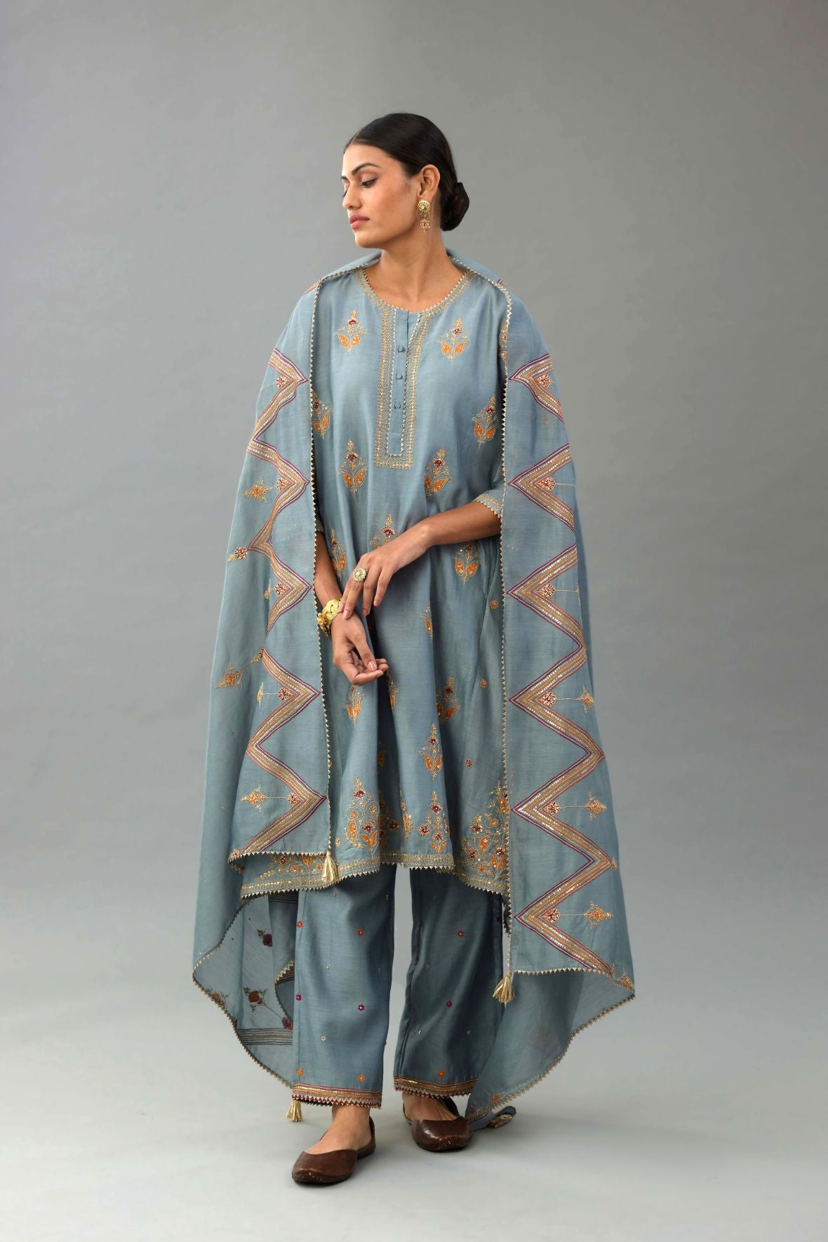 Light blue silk chanderi A-line short kurta set with dori and contrast silk thread embroidery, highlighted with gold sequins work.