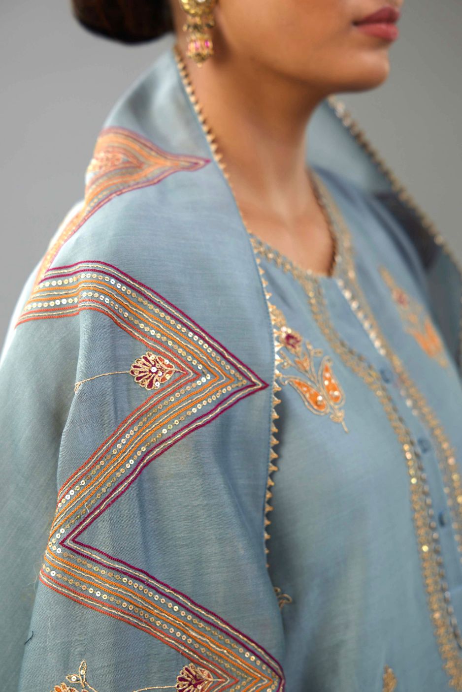 Light blue silk chanderi A-line short kurta set with dori and contrast silk thread embroidery, highlighted with gold sequins work.