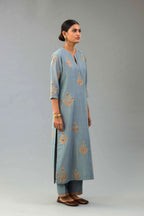 Light blue silk chanderi straight kurta set with zari, dori and contrast silk thread embroidered bootas, highlighted with gold sequins work.