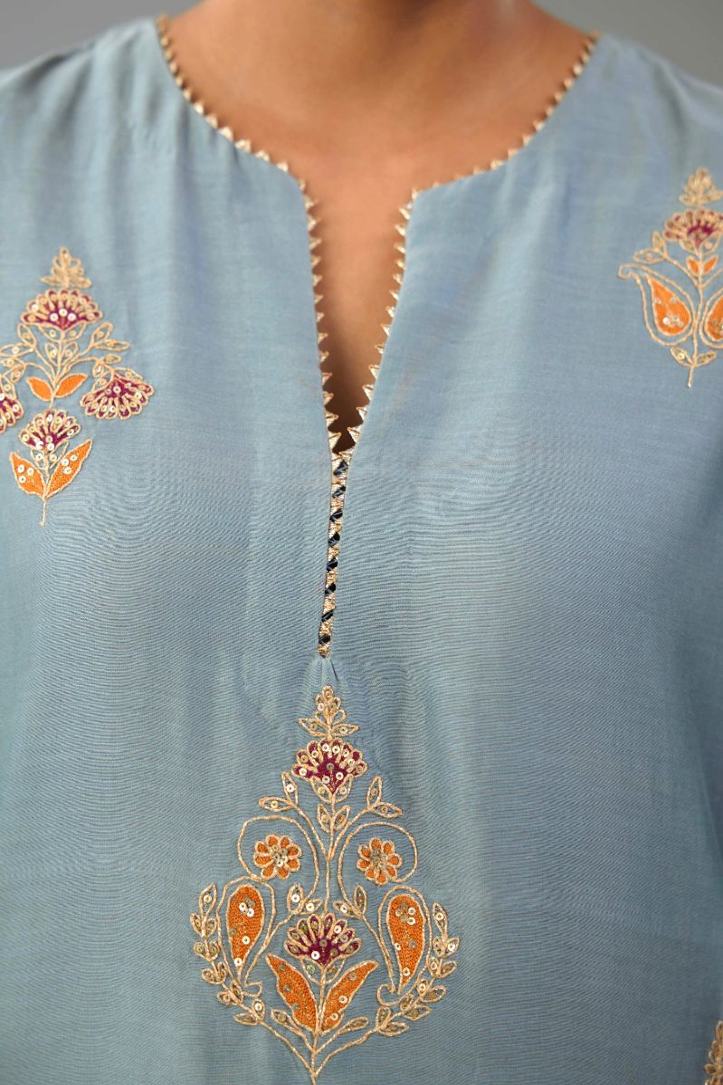 Light blue silk chanderi straight kurta set with zari, dori and contrast silk thread embroidered bootas, highlighted with gold sequins work.