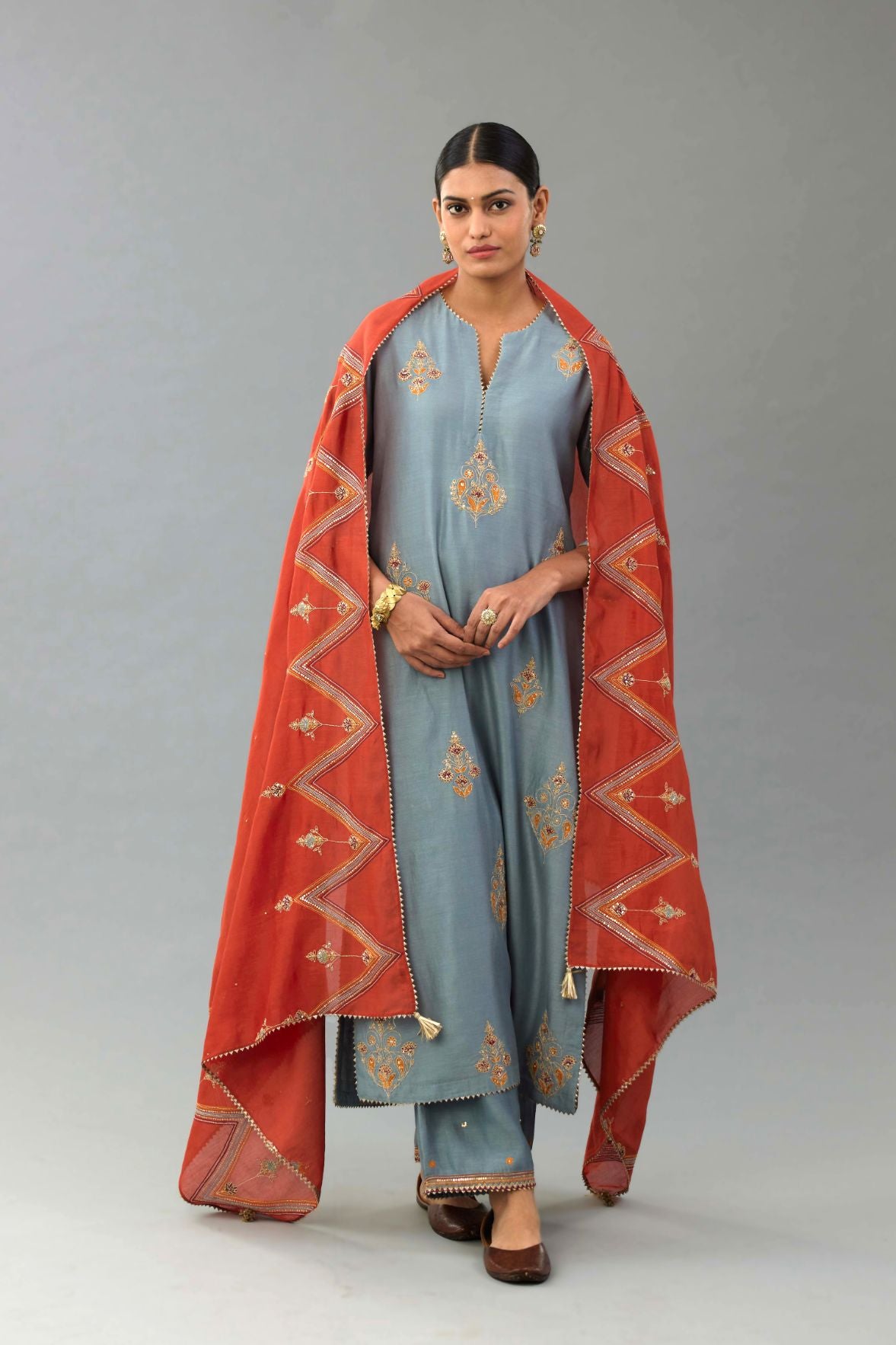 Light blue silk chanderi straight kurta set with zari, dori and contrast silk thread embroidered bootas, highlighted with gold sequins work.