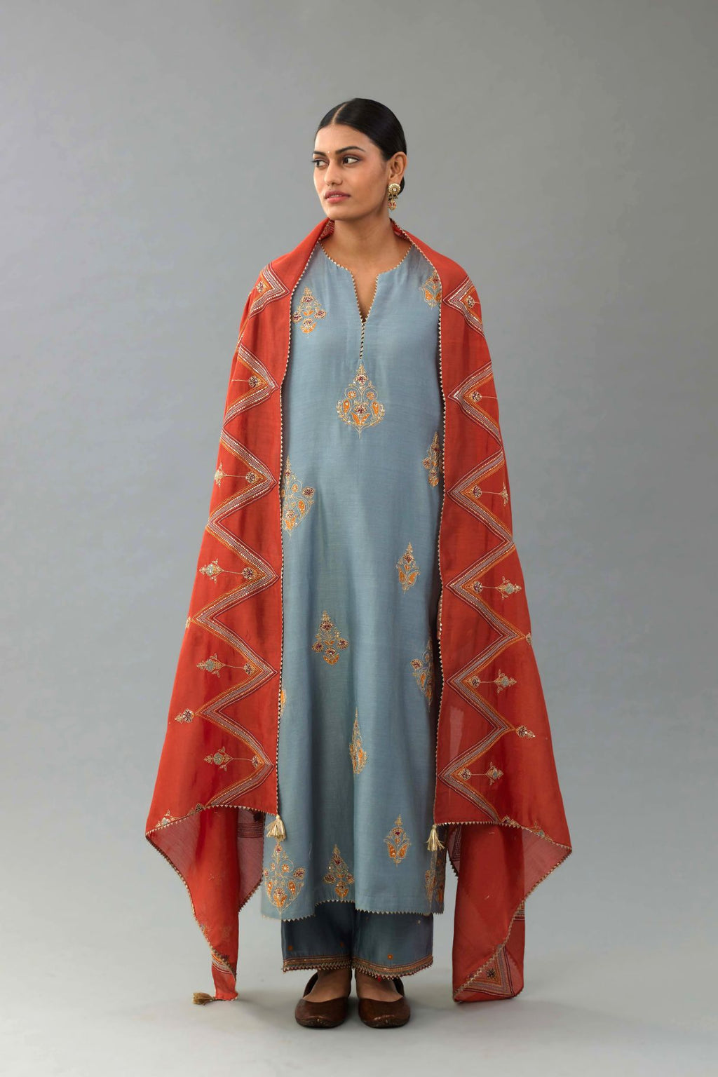 Light blue silk chanderi straight kurta set with zari, dori and contrast silk thread embroidered bootas, highlighted with gold sequins work.