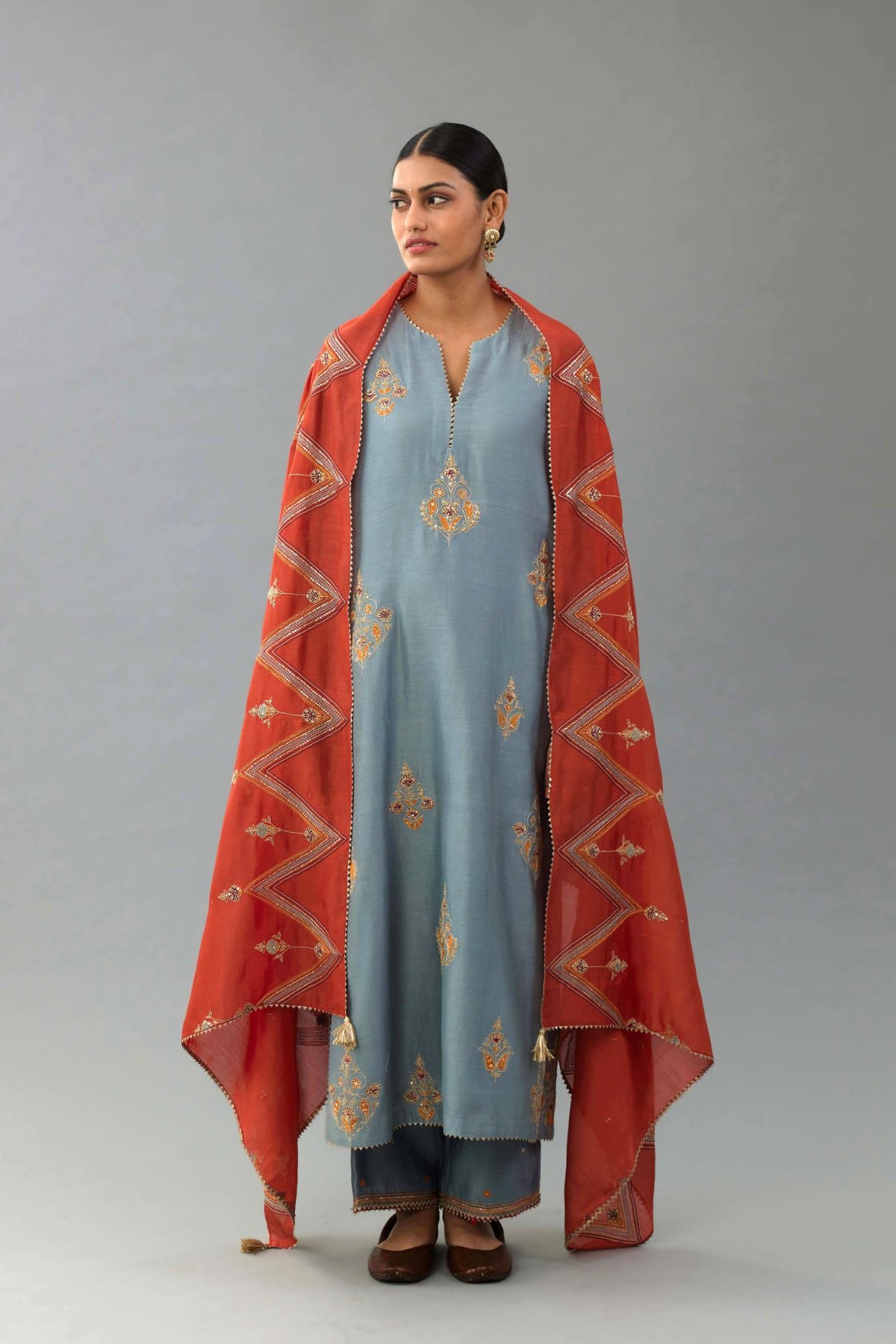 Light blue silk chanderi straight kurta set with zari, dori and contrast silk thread embroidered bootas, highlighted with gold sequins work.