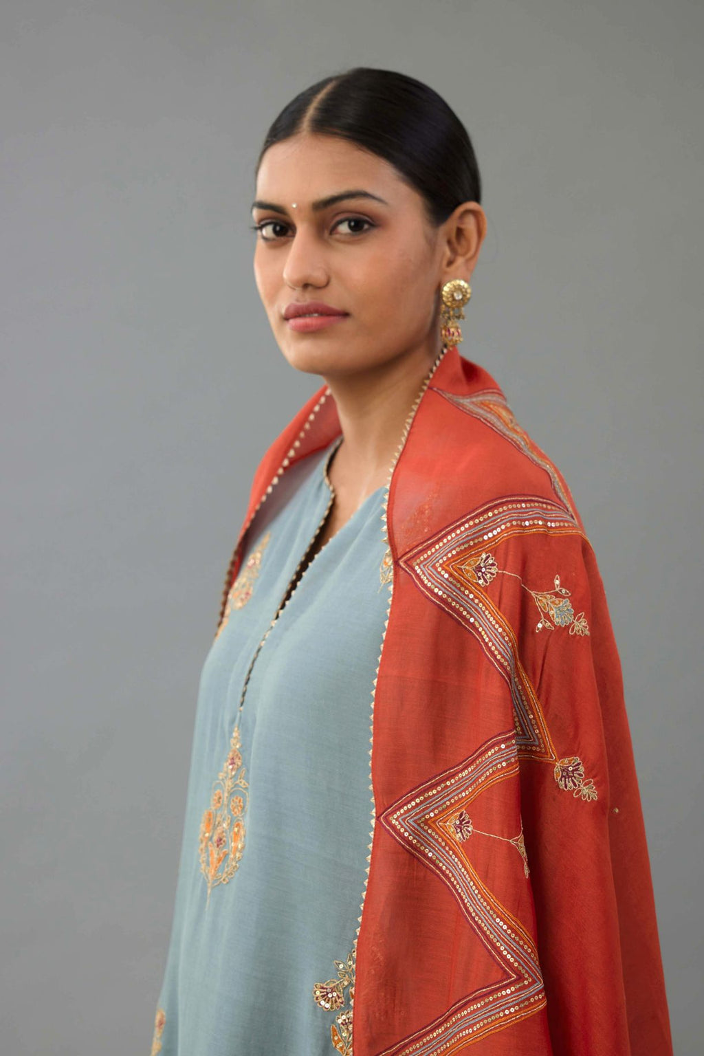 Light blue silk chanderi straight kurta set with zari, dori and contrast silk thread embroidered bootas, highlighted with gold sequins work.