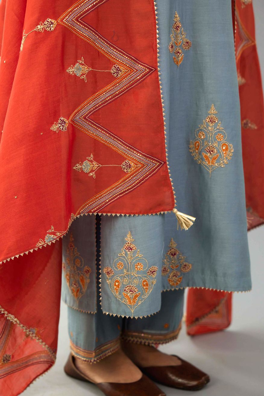 Light blue silk chanderi straight kurta set with zari, dori and contrast silk thread embroidered bootas, highlighted with gold sequins work.