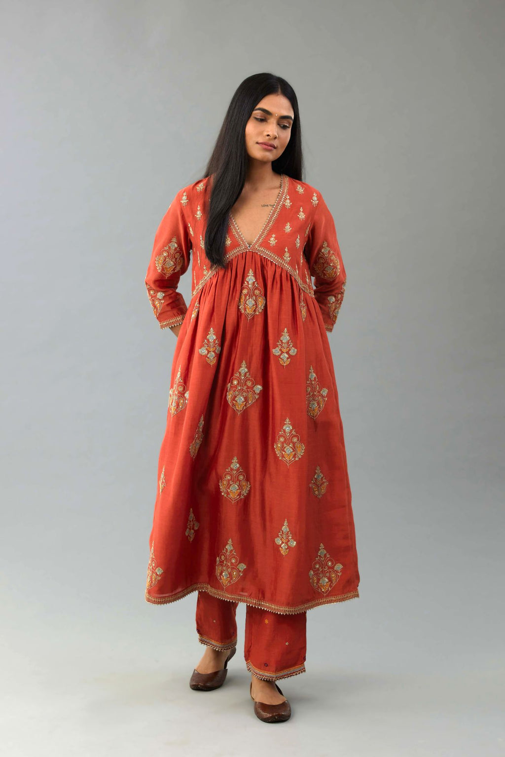 Rust silk chanderi kurta-dress set with all-over zari, dori and contrast silk thread embroidery, highlighted with gold sequins work.