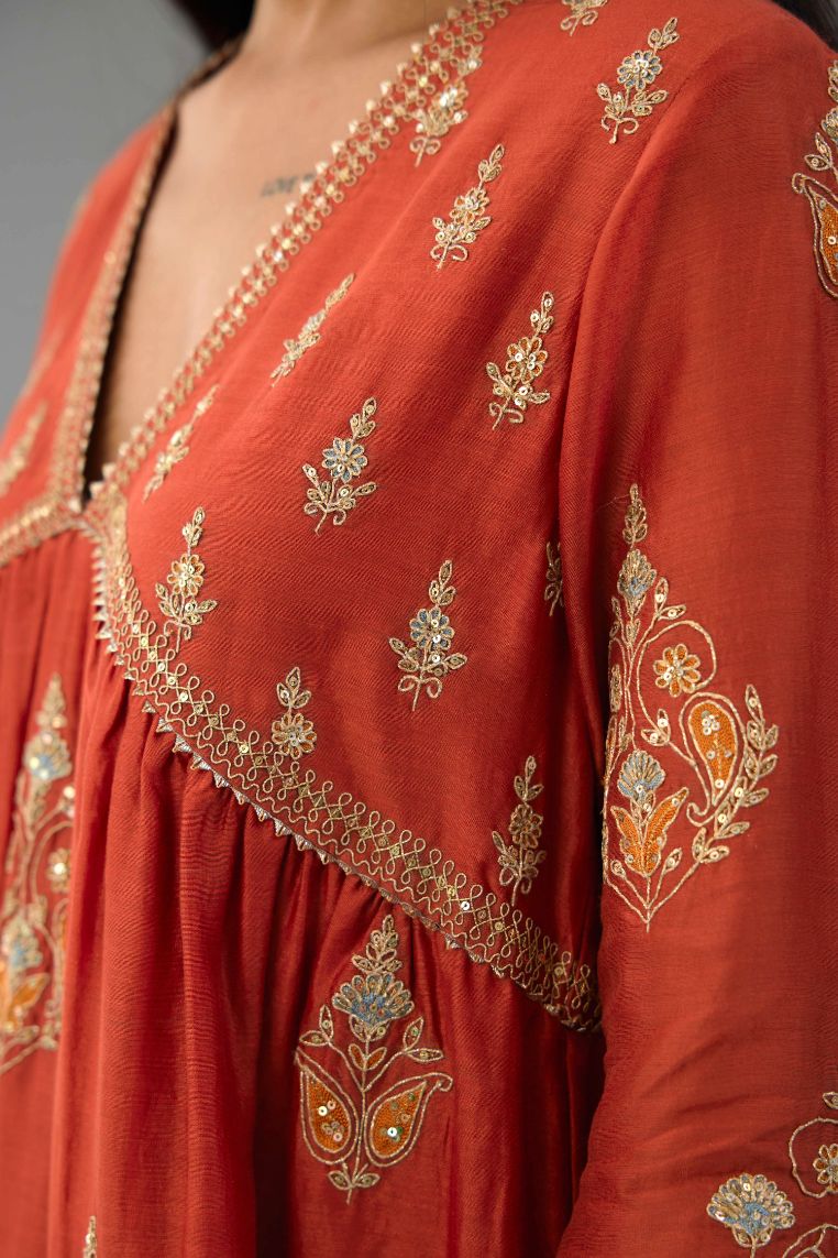 Rust silk chanderi kurta-dress set with all-over zari, dori and contrast silk thread embroidery, highlighted with gold sequins work.