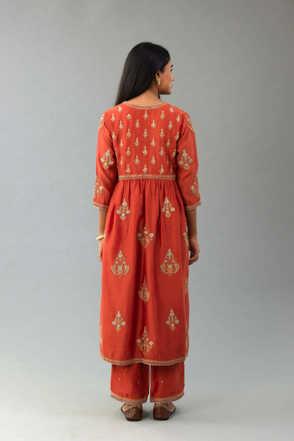 Rust silk chanderi kurta-dress set with all-over zari, dori and contrast silk thread embroidery, highlighted with gold sequins work.