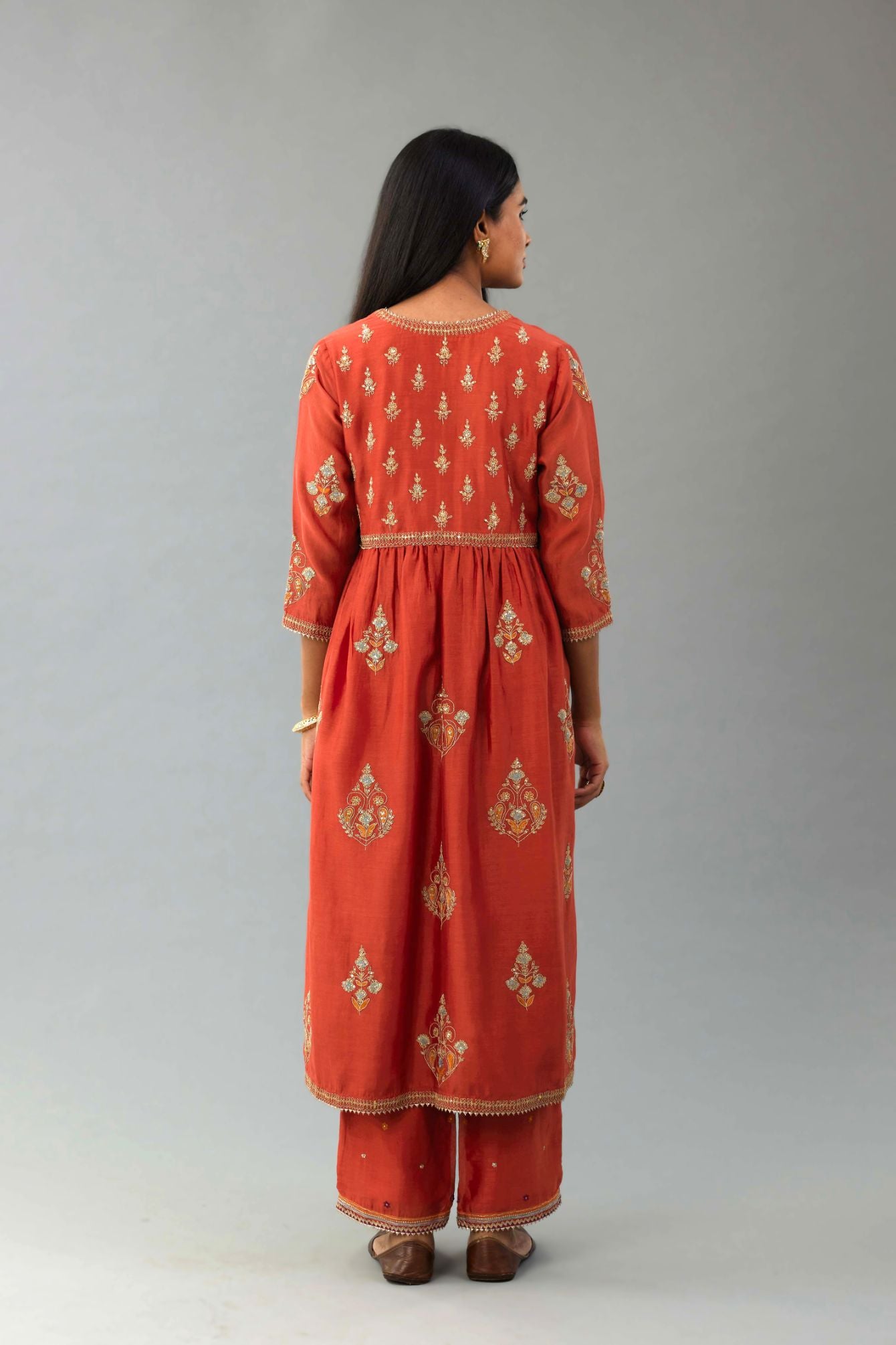Rust silk chanderi kurta-dress set with all-over zari, dori and contrast silk thread embroidery, highlighted with gold sequins work.