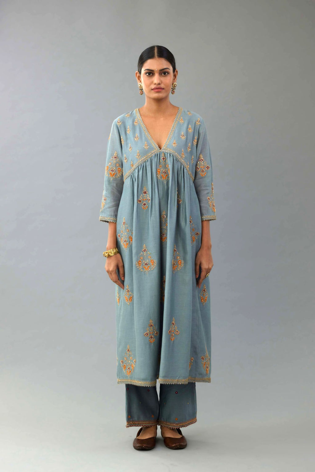 Light blue silk chanderi kurta-dress set with all-over zari, dori and contrast silk thread embroidery, highlighted with gold sequins work.