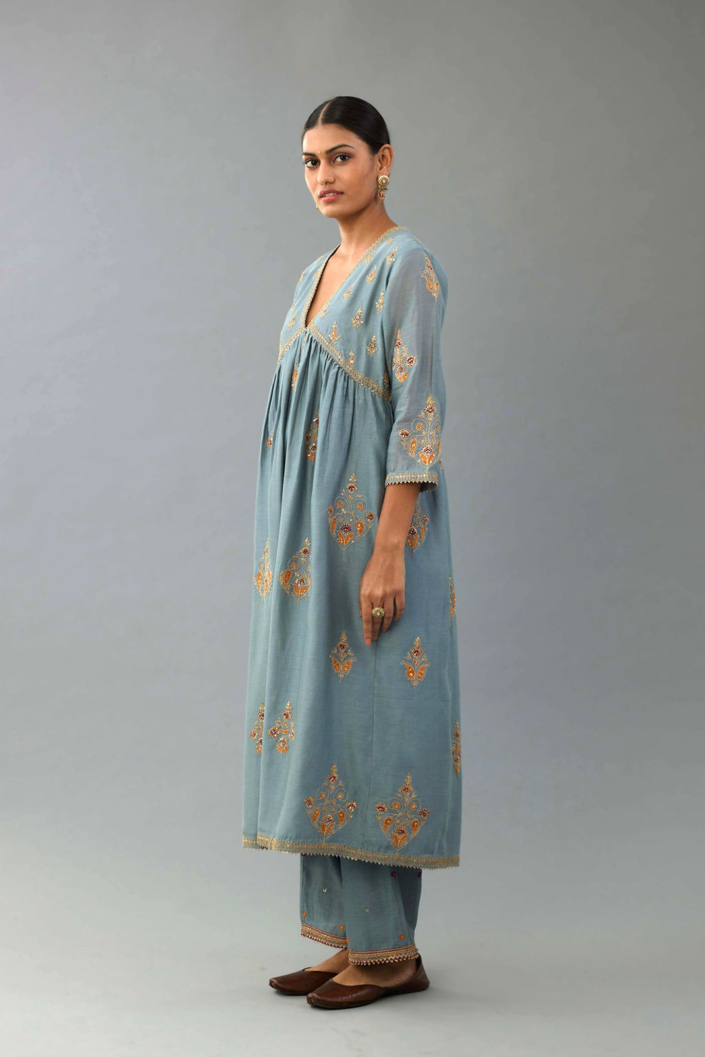 Light blue silk chanderi kurta-dress set with all-over zari, dori and contrast silk thread embroidery, highlighted with gold sequins work.