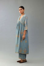 Light blue silk chanderi kurta-dress set with all-over zari, dori and contrast silk thread embroidery, highlighted with gold sequins work.
