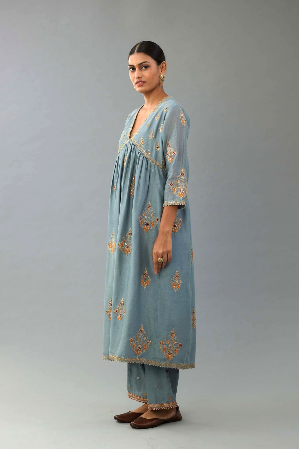 Light blue silk chanderi kurta-dress set with all-over zari, dori and contrast silk thread embroidery, highlighted with gold sequins work.