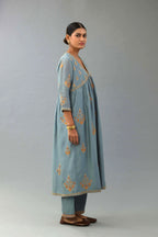 Light blue silk chanderi kurta-dress set with all-over zari, dori and contrast silk thread embroidery, highlighted with gold sequins work.