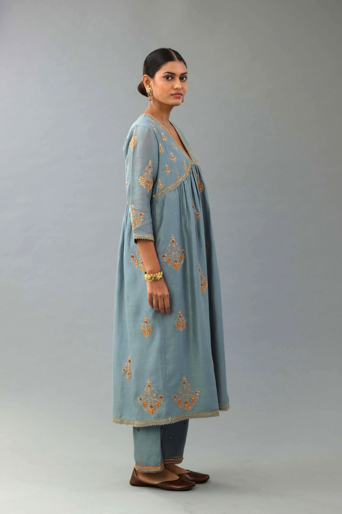 Light blue silk chanderi kurta-dress set with all-over zari, dori and contrast silk thread embroidery, highlighted with gold sequins work.