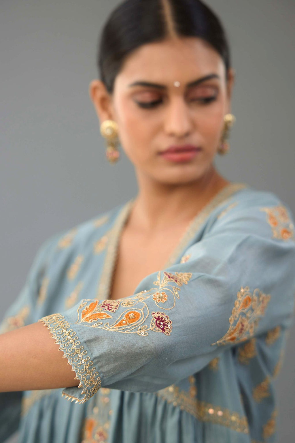 Light blue silk chanderi kurta-dress set with all-over zari, dori and contrast silk thread embroidery, highlighted with gold sequins work.