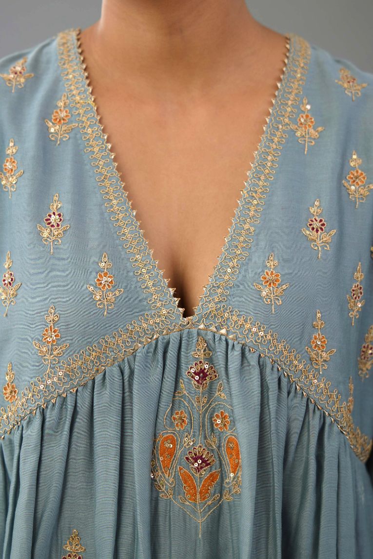 Light blue silk chanderi kurta-dress set with all-over zari, dori and contrast silk thread embroidery, highlighted with gold sequins work.