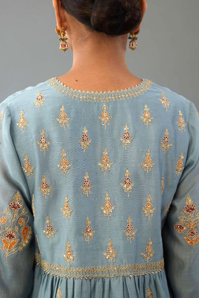 Light blue silk chanderi kurta-dress set with all-over zari, dori and contrast silk thread embroidery, highlighted with gold sequins work.
