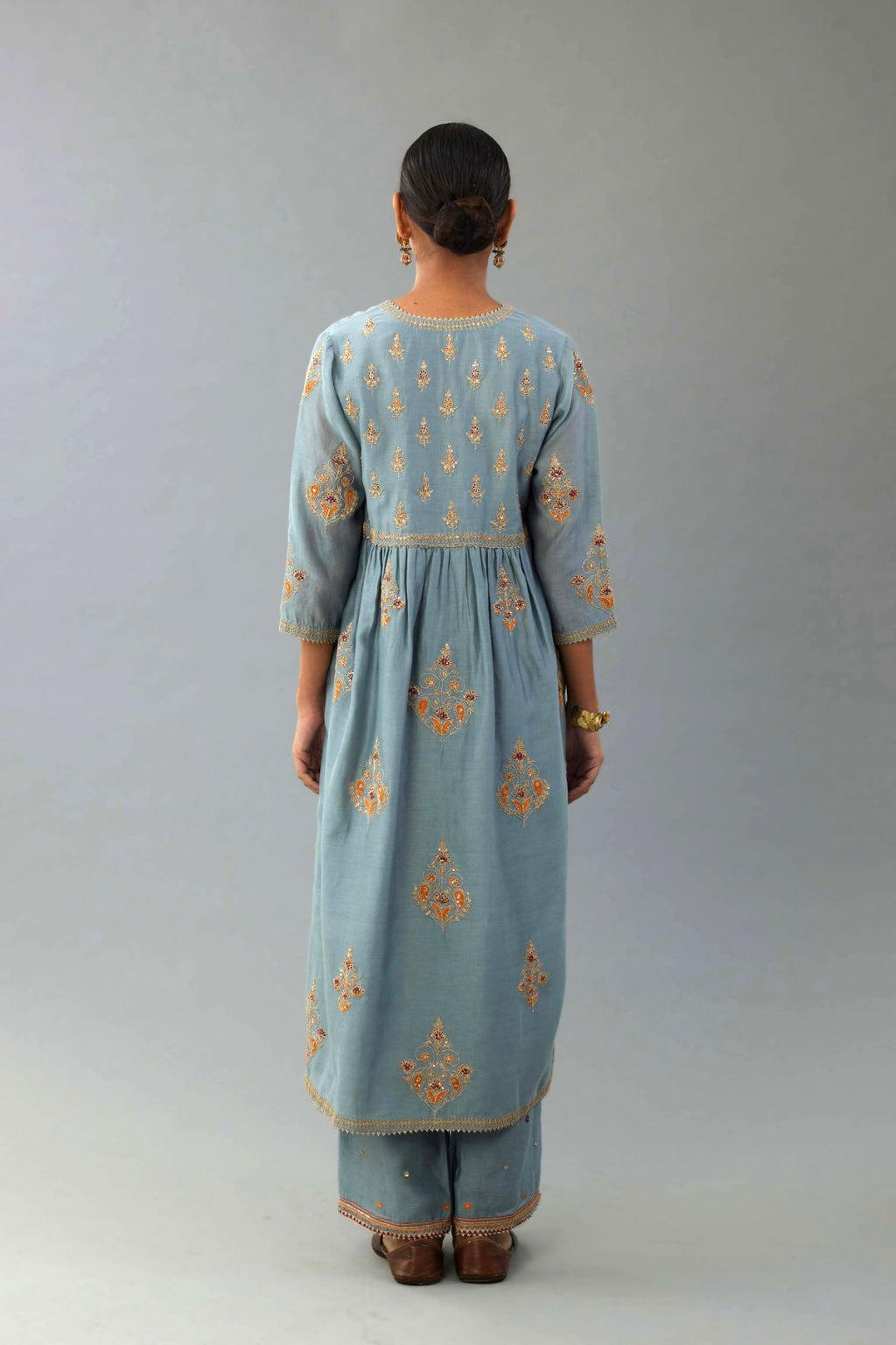 Light blue silk chanderi kurta-dress set with all-over zari, dori and contrast silk thread embroidery, highlighted with gold sequins work.