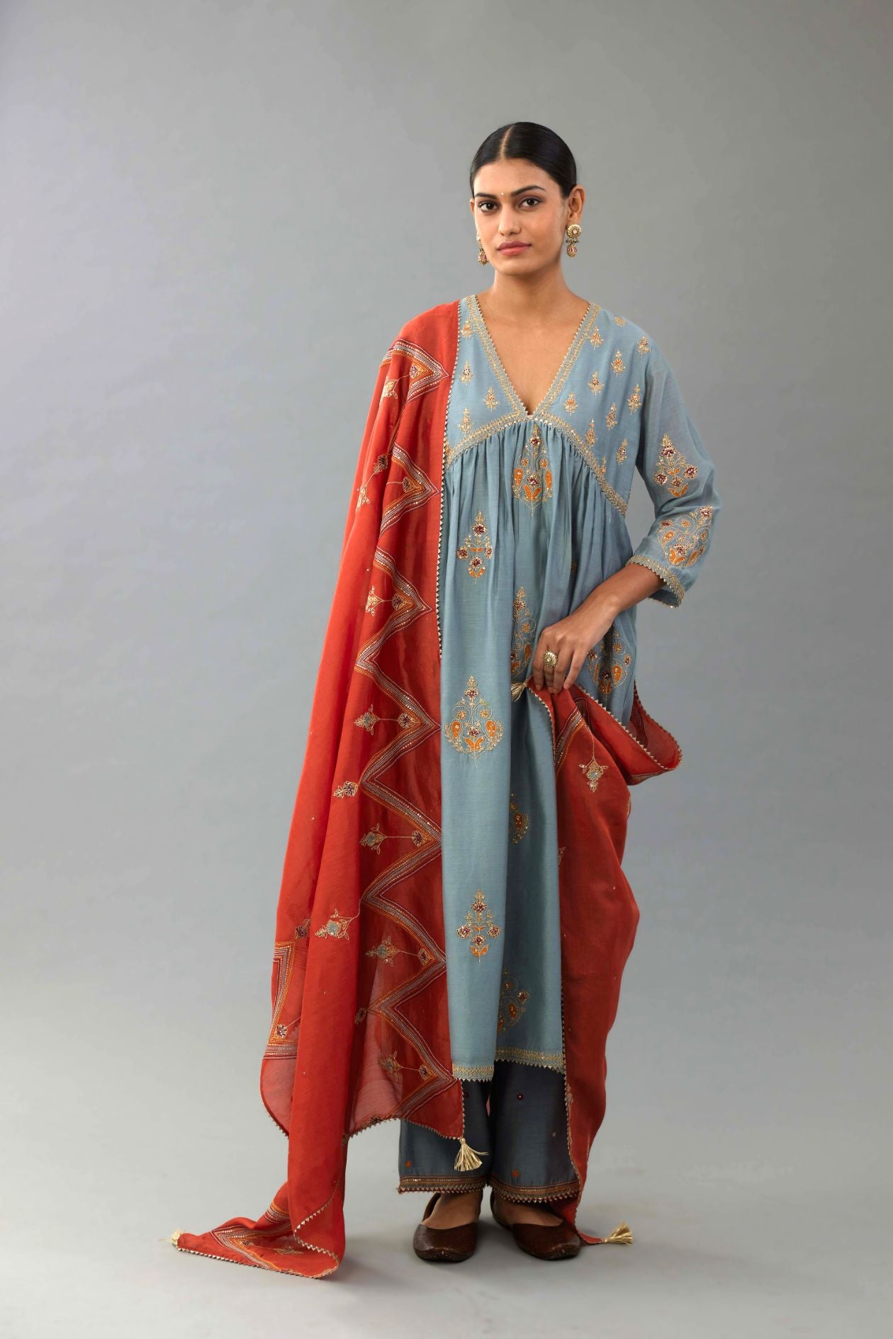 Light blue silk chanderi kurta-dress set with all-over zari, dori and contrast silk thread embroidery, highlighted with gold sequins work.
