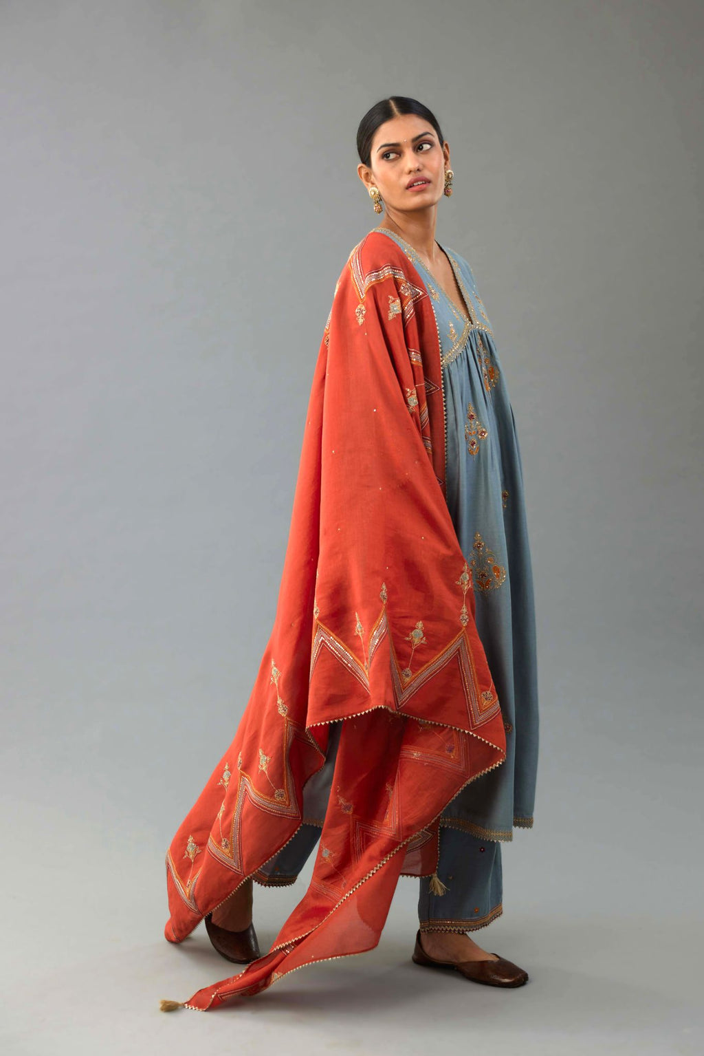 Light blue silk chanderi kurta-dress set with all-over zari, dori and contrast silk thread embroidery, highlighted with gold sequins work.