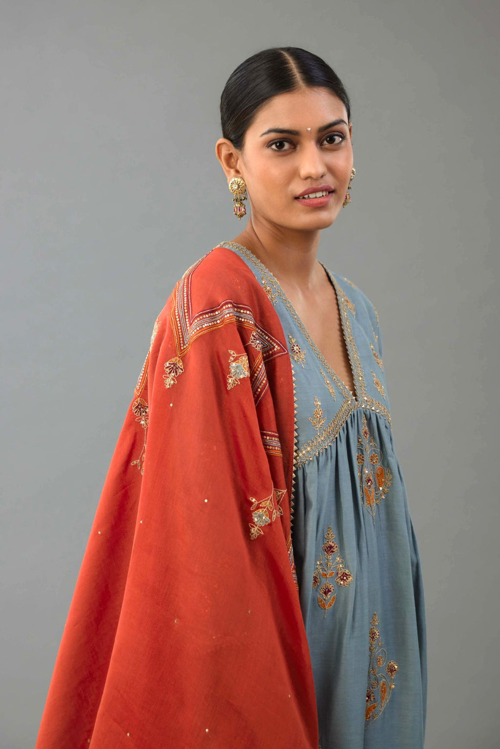 Light blue silk chanderi kurta-dress set with all-over zari, dori and contrast silk thread embroidery, highlighted with gold sequins work.