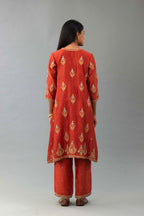 Rust silk chanderi A-line short kurta set with dori and contrast silk thread embroidery, highlighted with gold sequins work.