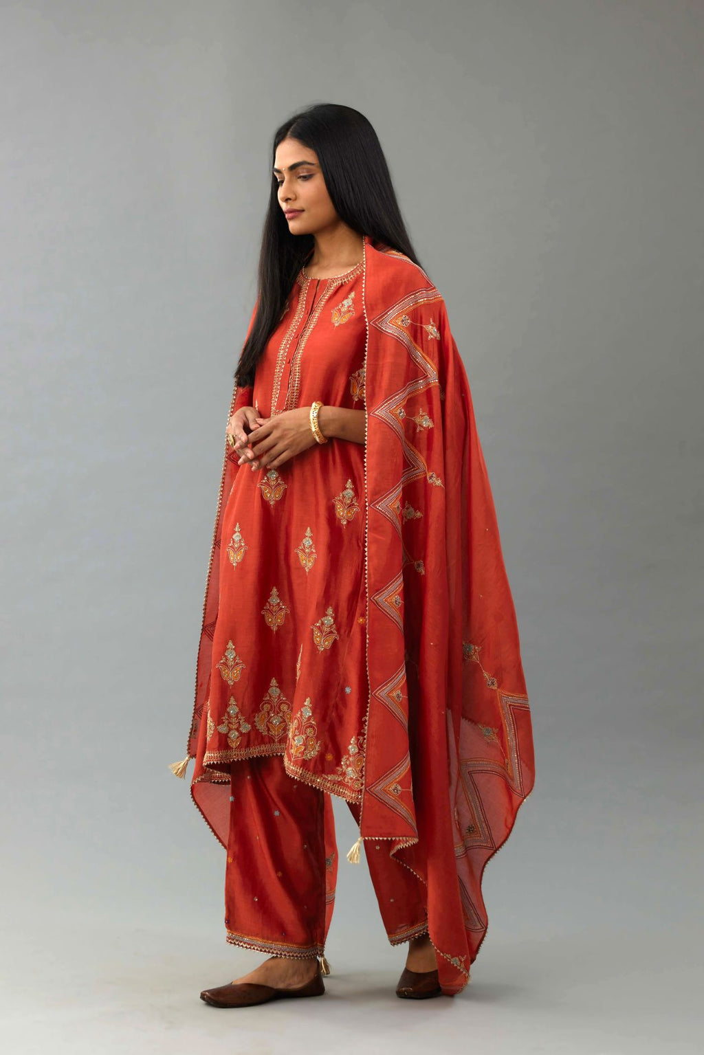 Rust Silk chanderi dupatta in chevron pattern embroidery with contrast silk thread and dori at the sides.