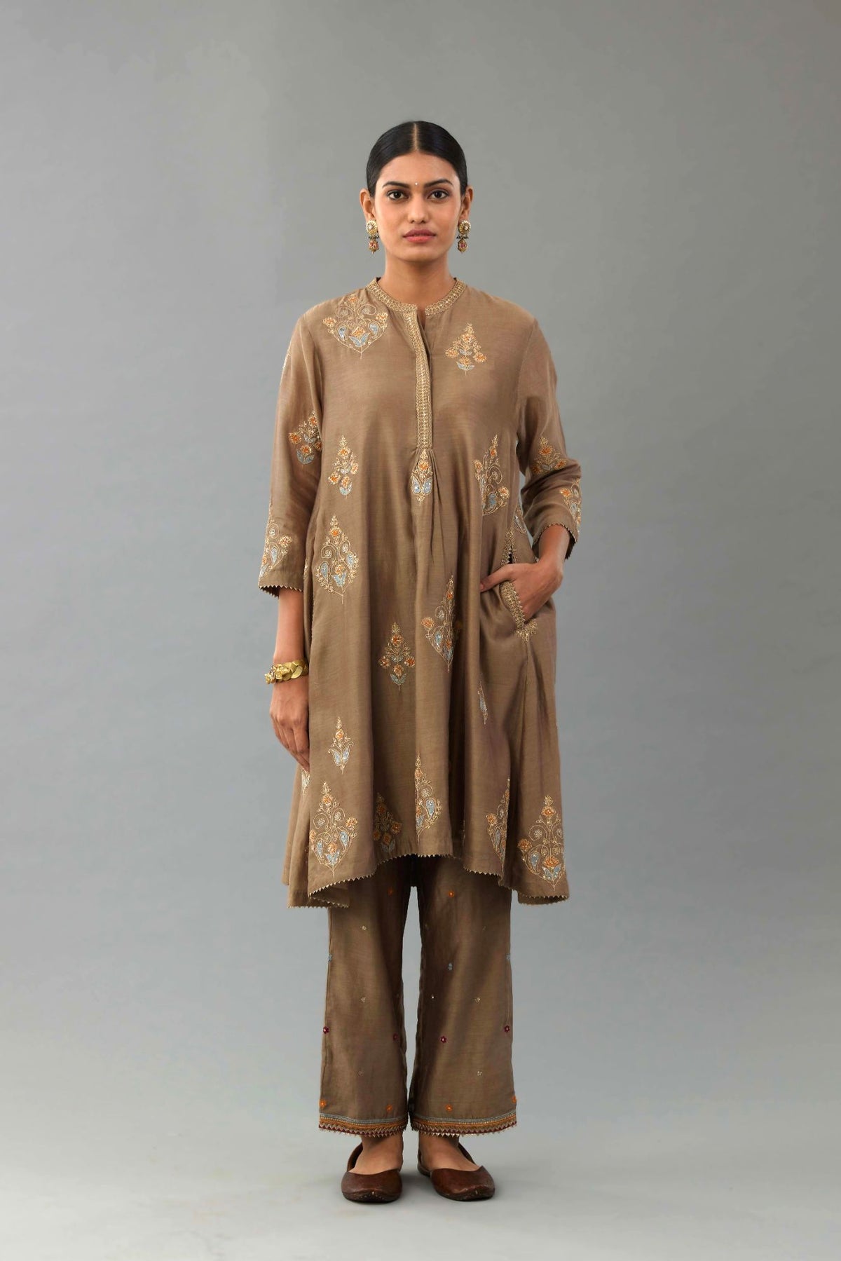 Taupe Silk Chanderi short kurta set with collar and front placket, detailed with delicate gold embroidery is done around the placket and collar.