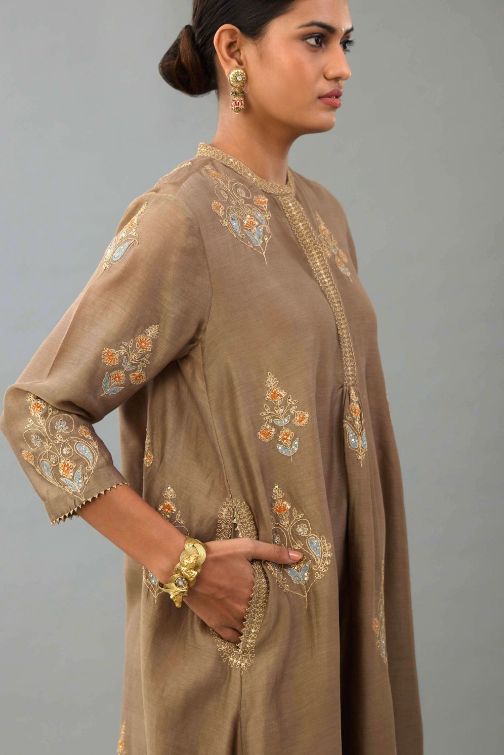 Taupe Silk Chanderi short kurta set with collar and front placket, detailed with delicate gold embroidery is done around the placket and collar.