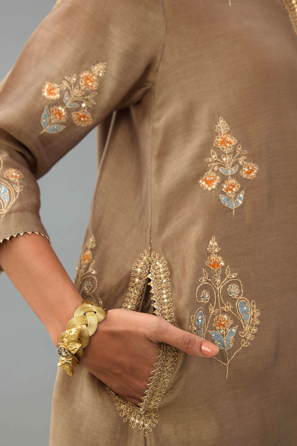 Taupe Silk Chanderi short kurta set with collar and front placket, detailed with delicate gold embroidery is done around the placket and collar.