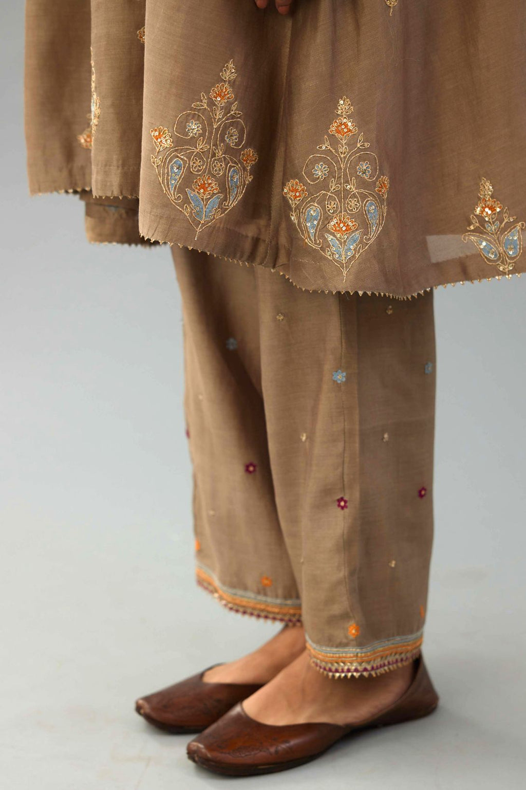 Taupe Silk Chanderi short kurta set with collar and front placket, detailed with delicate gold embroidery is done around the placket and collar.