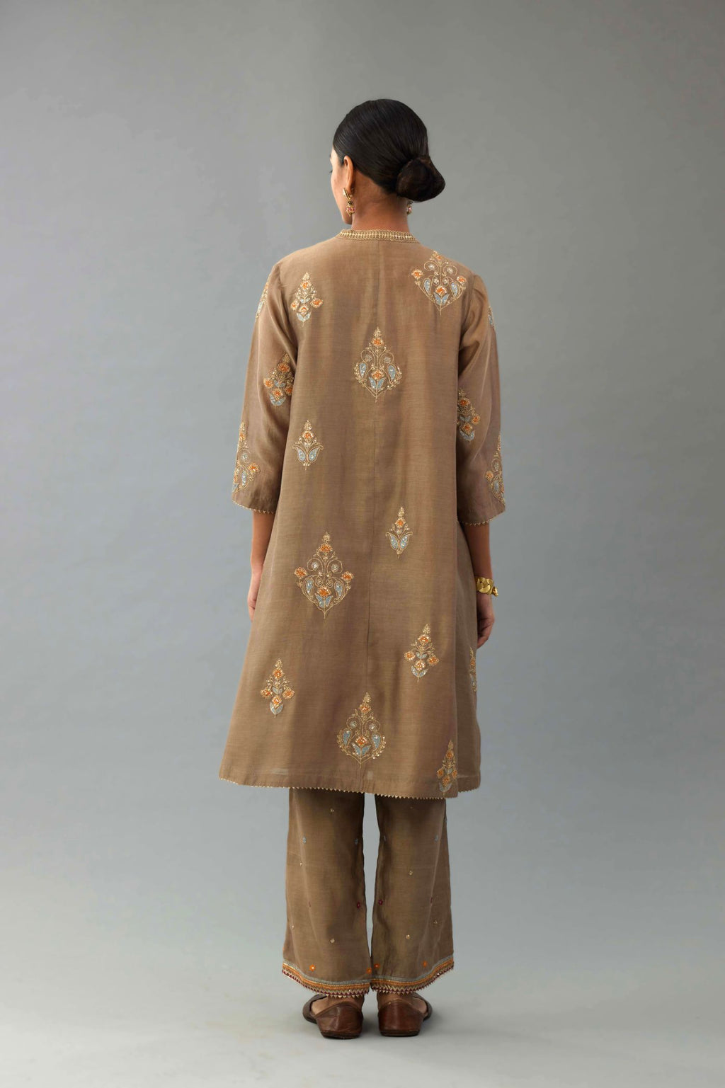 Taupe Silk Chanderi short kurta set with collar and front placket, detailed with delicate gold embroidery is done around the placket and collar.