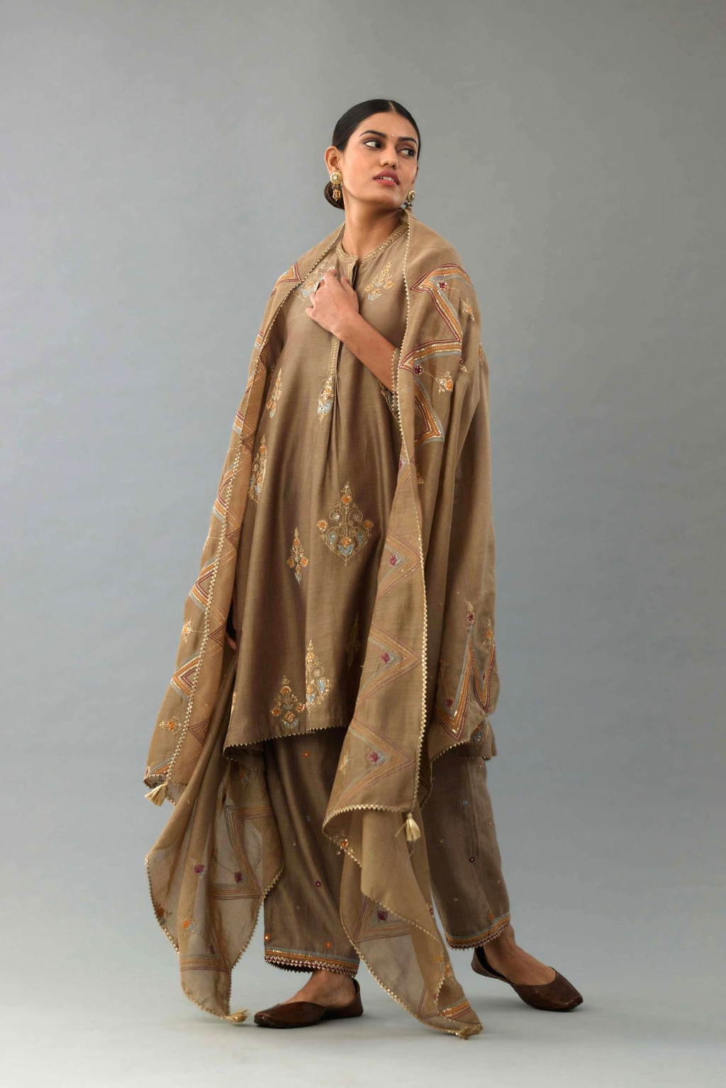 Taupe Silk Chanderi short kurta set with collar and front placket, detailed with delicate gold embroidery is done around the placket and collar.