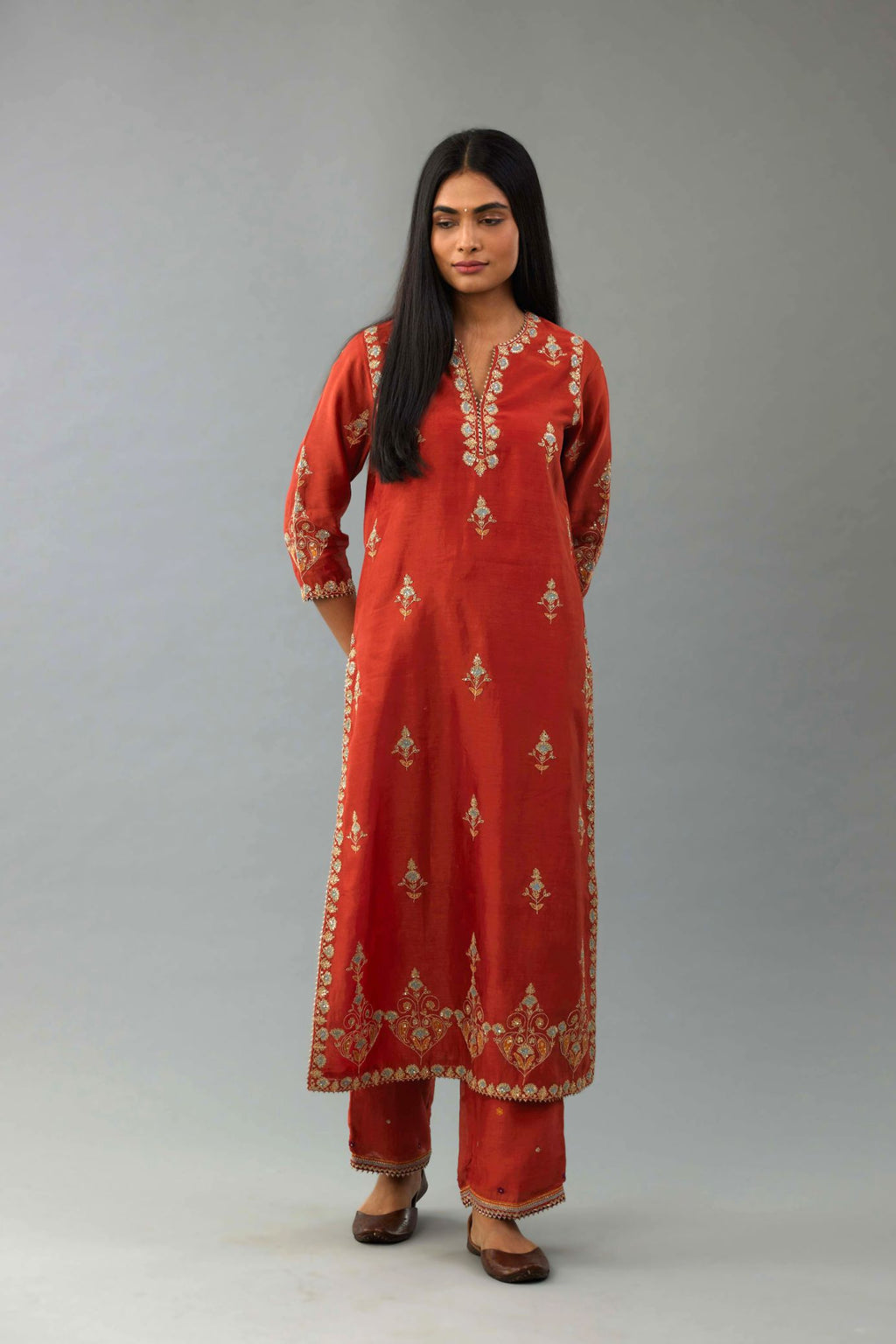 Rust silk chanderi straight kurta set with all-over zari, dori and contrast silk thread embroidery, highlighted with gold sequins work.