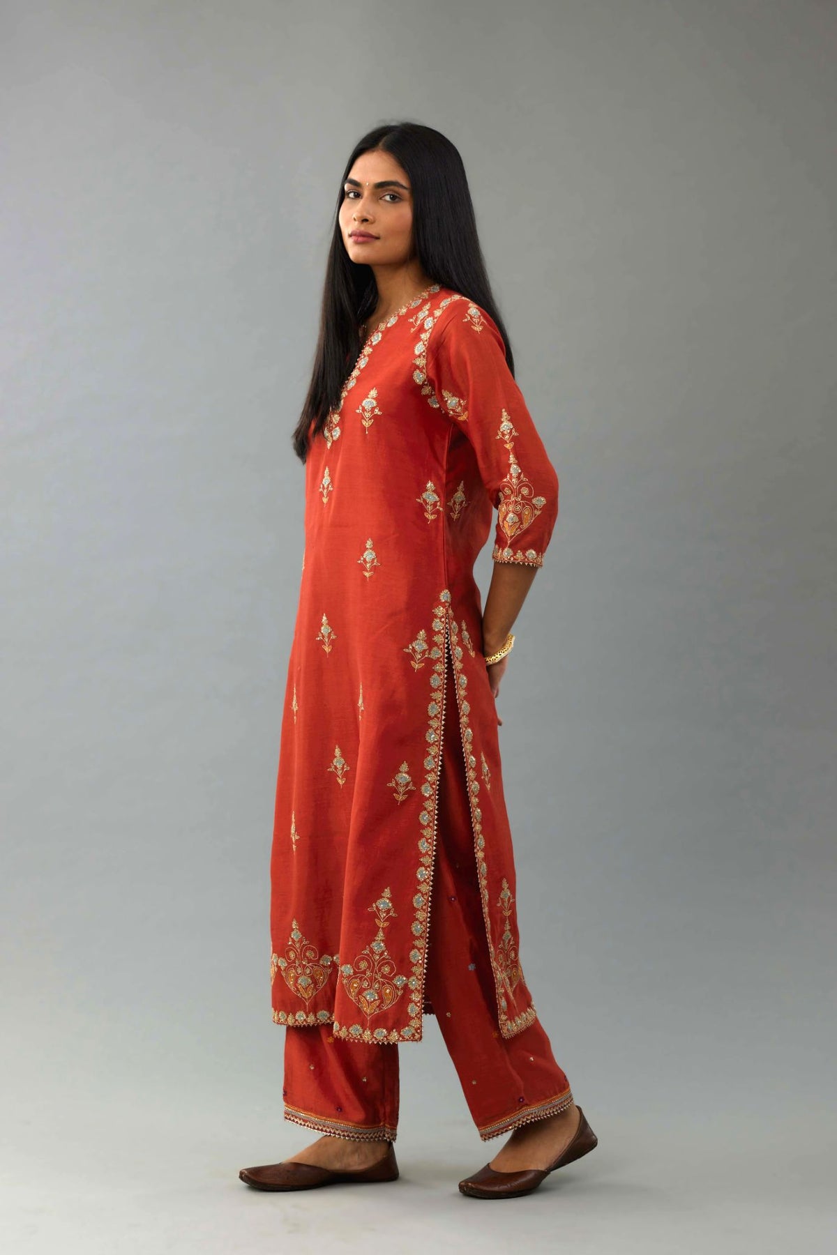 Rust silk chanderi straight kurta set with all-over zari, dori and contrast silk thread embroidery, highlighted with gold sequins work.