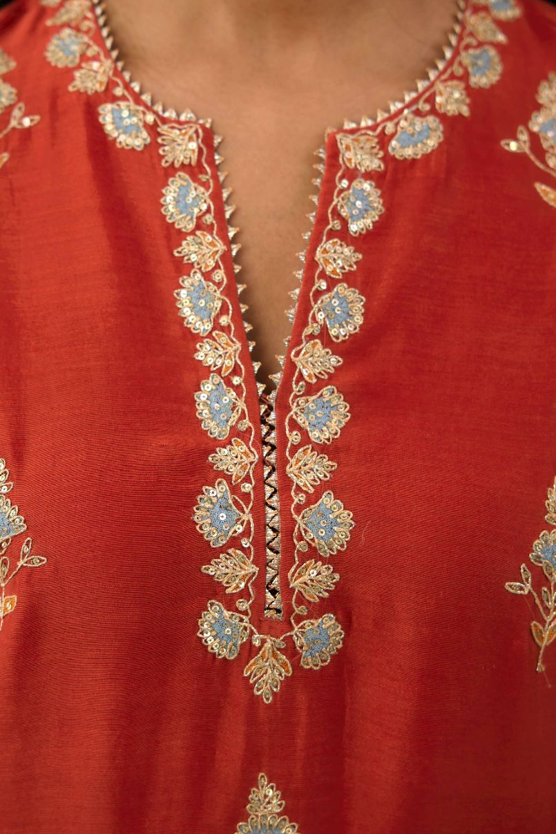 Rust silk chanderi straight kurta set with all-over zari, dori and contrast silk thread embroidery, highlighted with gold sequins work.