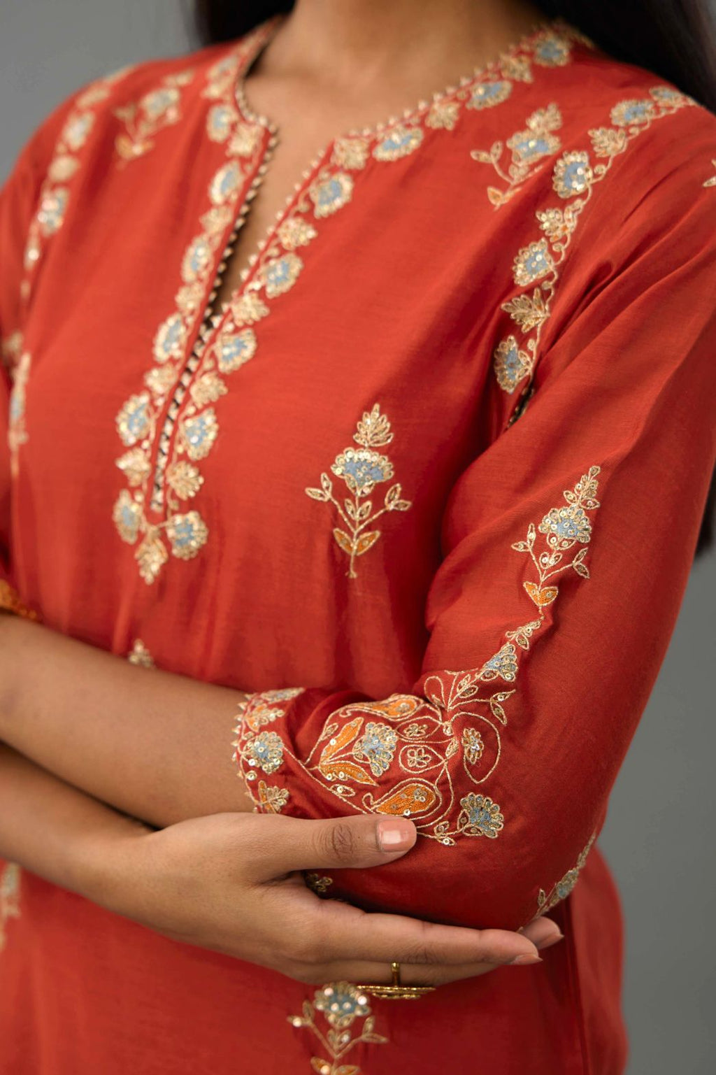 Rust silk chanderi straight kurta set with all-over zari, dori and contrast silk thread embroidery, highlighted with gold sequins work.