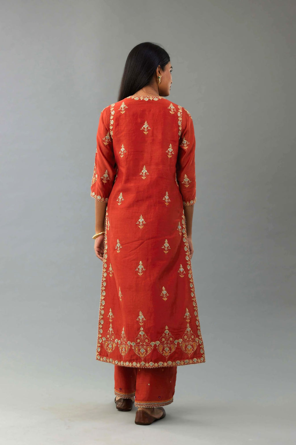 Rust silk chanderi straight kurta set with all-over zari, dori and contrast silk thread embroidery, highlighted with gold sequins work.