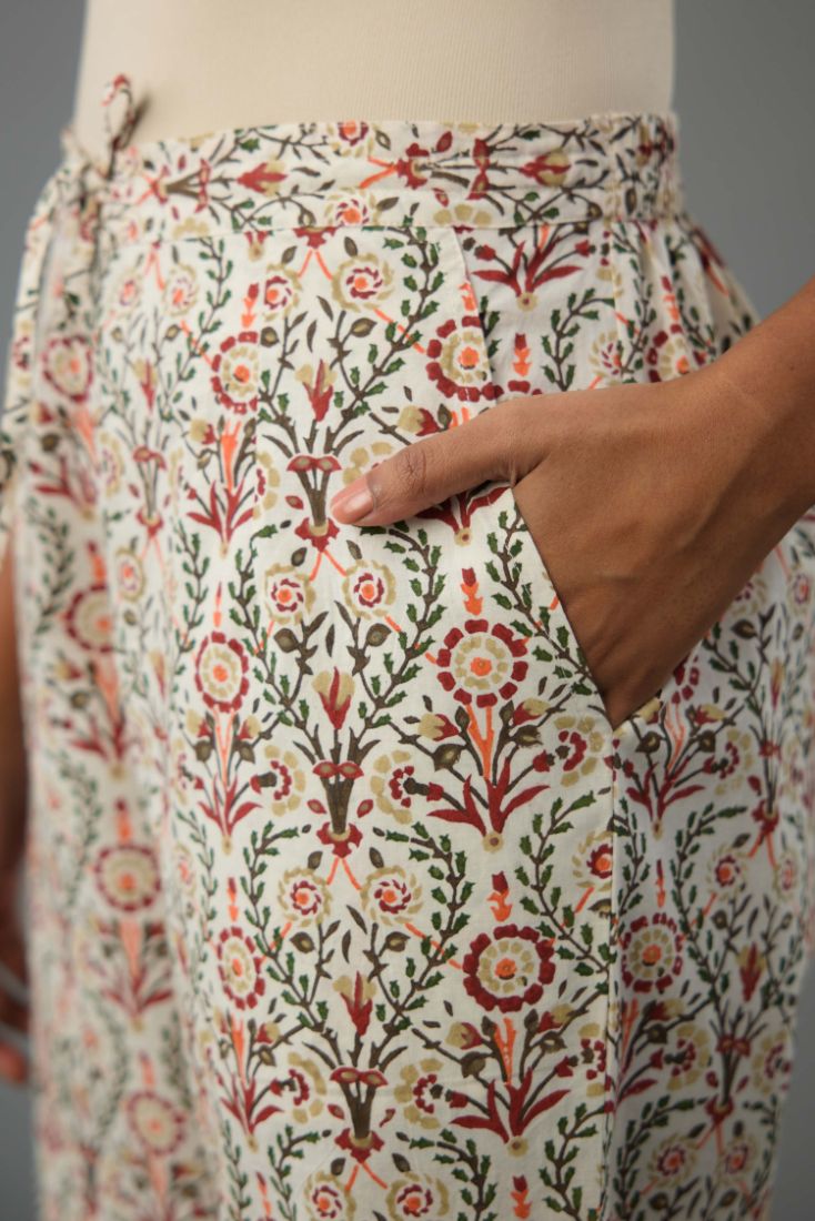 Red & green cotton short top with all-over hand block print, paired with blue and pink hand block printed cotton straight pants.