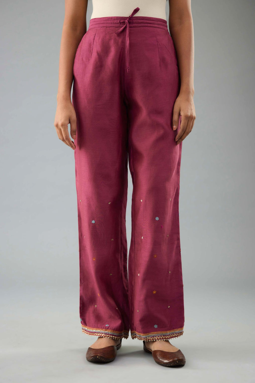 Wine silk chanderi straight pants with dori and contrast silk thread embroidery,  detailed with gold sequins work.