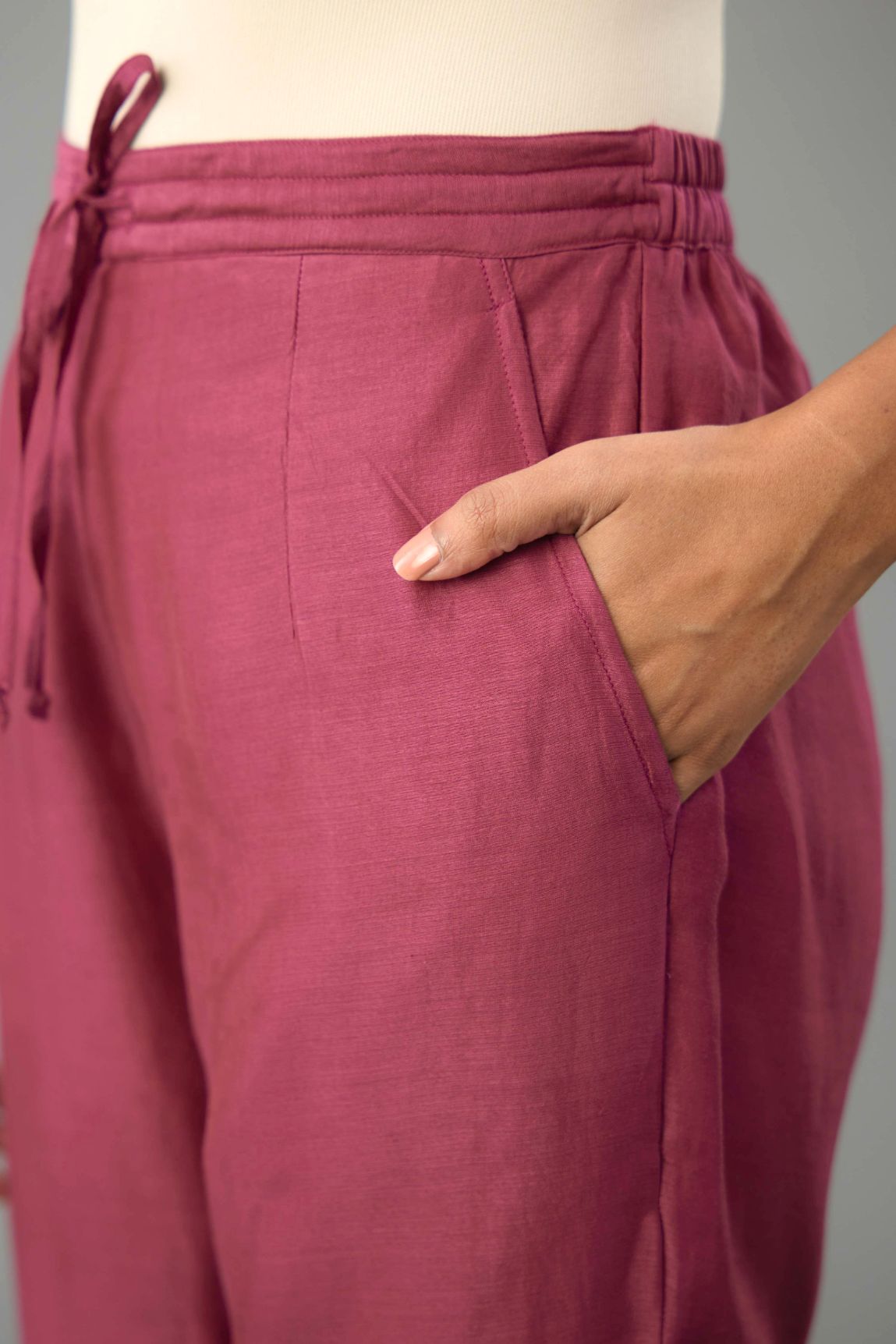 Wine silk chanderi straight pants with dori and contrast silk thread embroidery,  detailed with gold sequins work.