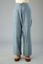 Light blue silk chanderi straight pants with dori and contrast silk thread embroidery,  detailed with gold sequins work.