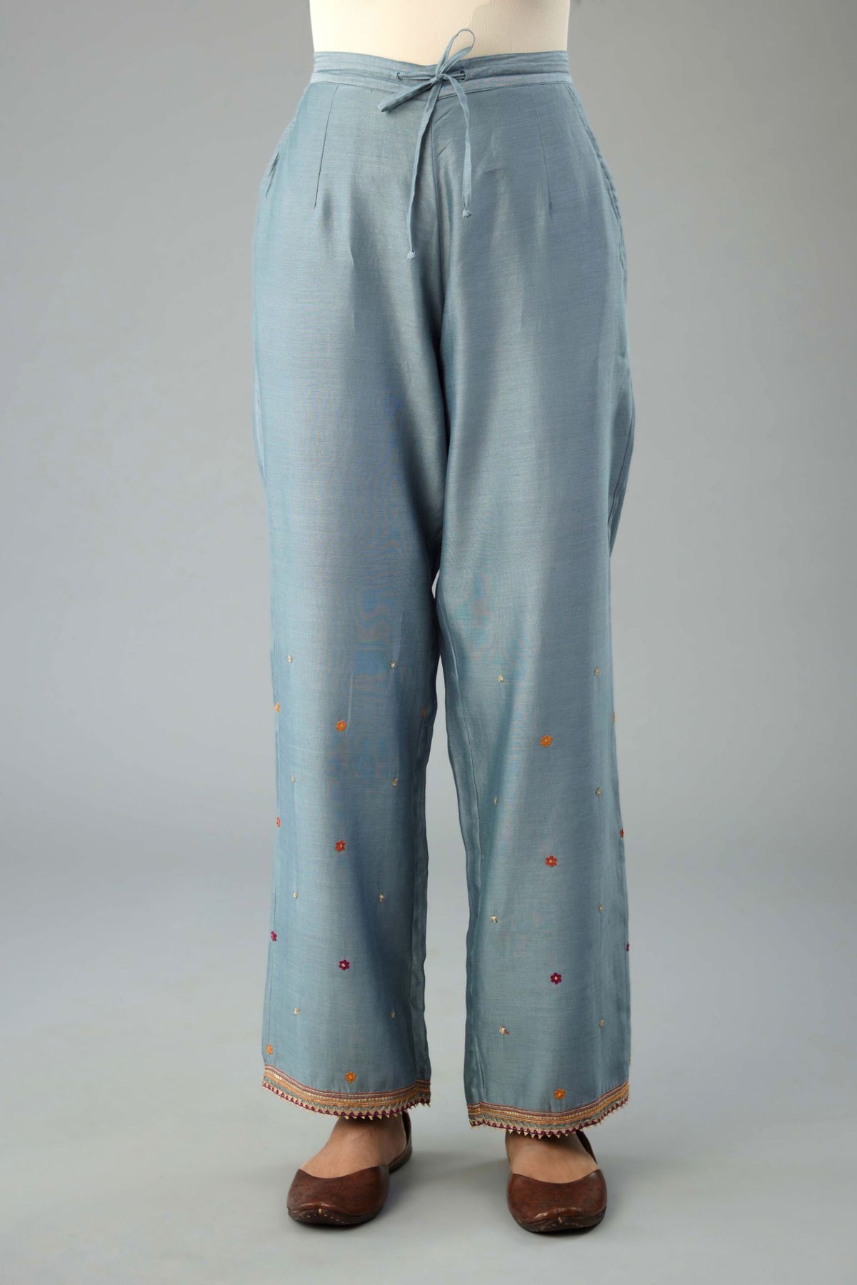 Light blue silk chanderi straight pants with dori and contrast silk thread embroidery,  detailed with gold sequins work.