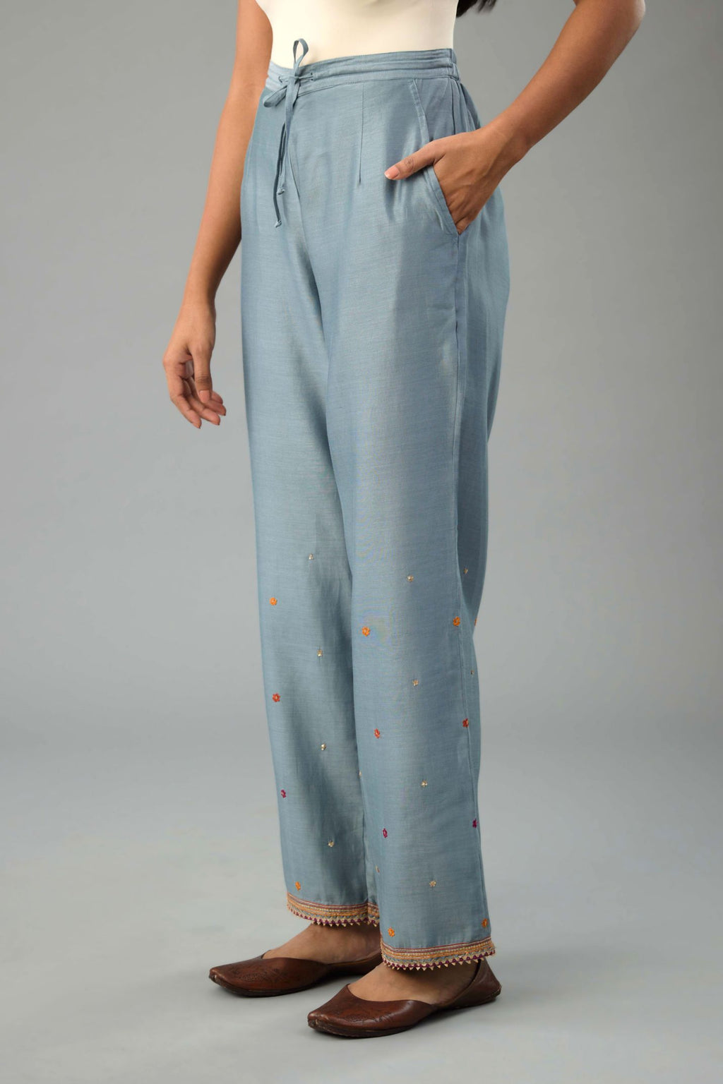 Light blue silk chanderi straight pants with dori and contrast silk thread embroidery,  detailed with gold sequins work.