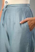 Light blue silk chanderi straight pants with dori and contrast silk thread embroidery,  detailed with gold sequins work.